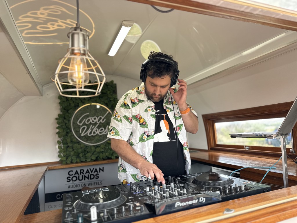 DJ listening to music through headphones whilst performing