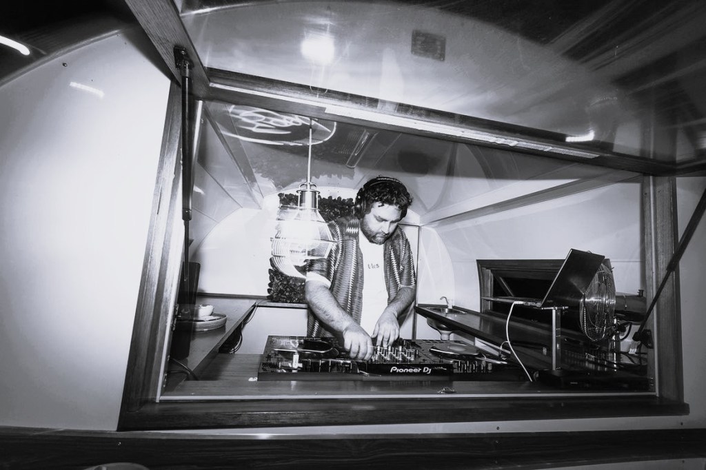 DJ performing in a caravan.